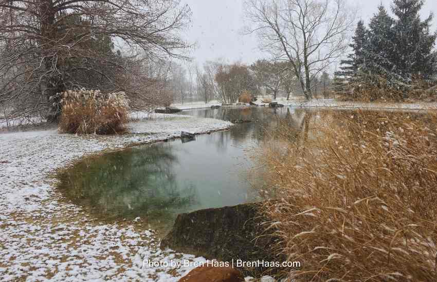 Early partially frozen pond in Ohio with landscape